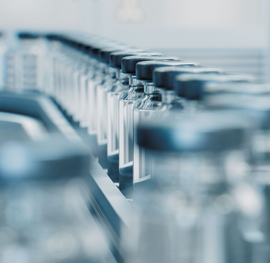 conveyor belt of vaccine bottles